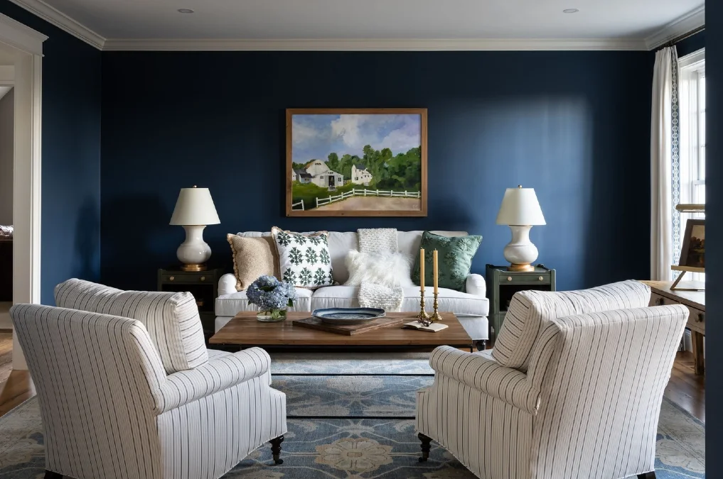 Crisp White Seating And Striped Armchairs Against Navy Walls