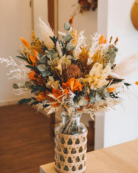 Orange Florals in a Cane-Wrapped Vase