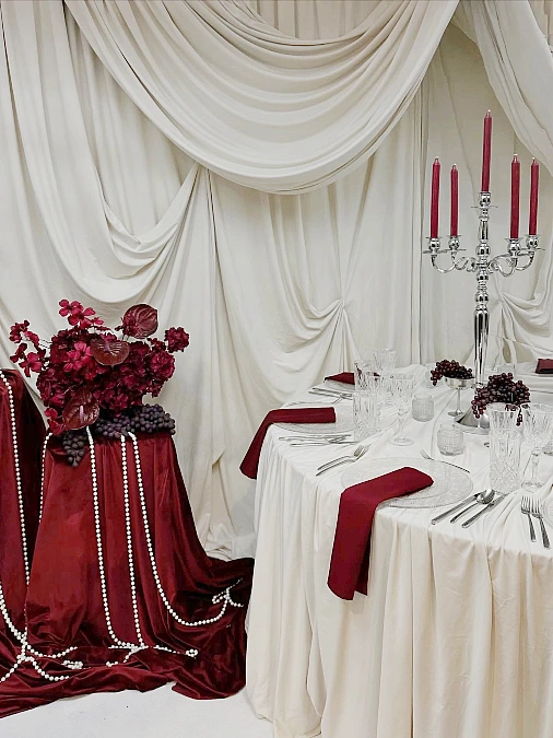 Burgundy Candles on an Ivory Table